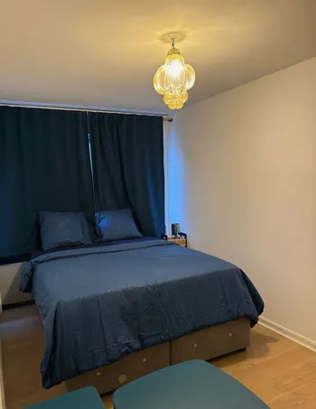Blue bedroom with golden chandelier