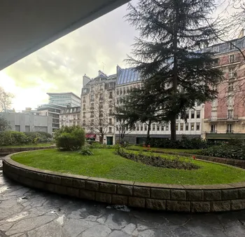 Courtyard garden with stone border and tree