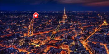 Eiffel tower illuminated at night from high vantage