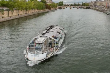 Sightseeing boat cruising along Seine river